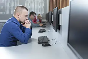 One Person Working On Computer Drucke: Man working in the computer room at university