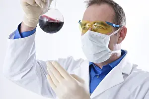 Caucasian Male Researcher Drucke: Man working on an experiment in a laboratory