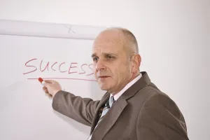 Studio Shot Of A Manager Drucke: Manager standing in front of a flip chart