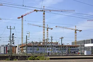 Southern German Architecture Drucke: Mannheim, Germany, July 2019: Big construction area surrounded by multiple orange tower cranes next to main station