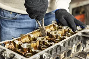 Car Engine Repair Drucke: The mechanic repairs the car engine in the workshop