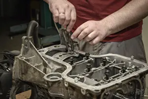 Deserted Workshop Scene Drucke: The mechanic repairs the car engine in the workshop