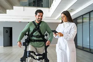 Modern Healthcare System Drucke: Mechanical exoskeleton, female doctor physiotherapist with disabled person with robotic skeleton in rehabilitation