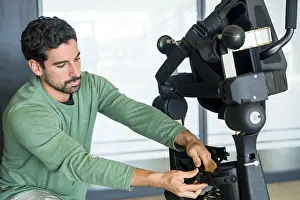 Modern Hospital Equipment Drucke: Mechanical exoskeleton engineer checking the mechanisms before the arrival of patients