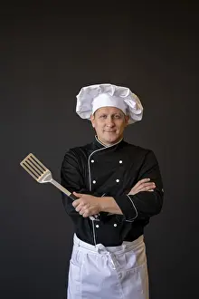 Meal Preparation Drucke: Medium shot chef posing with spatula