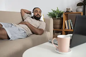 Modern Apartment Architecture Drucke: Medium shot man laying couch
