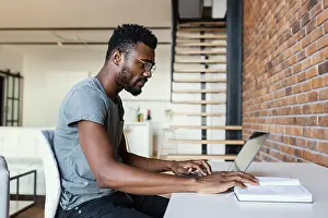 Entrepreneur At Work Drucke: Medium shot man working desk
