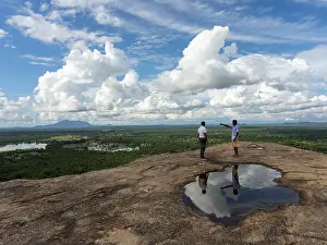 One Person In Nature Drucke: Men standing on rocks, reflection in a puddle