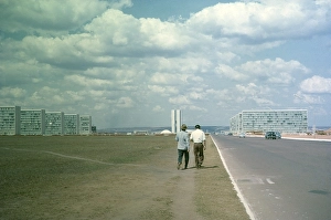 Historic City Center Brazil Drucke: Two men walking along a nondescript road next to cars