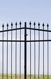 Abandoned Entrance Gate Drucke: A metal gate with sharp spears