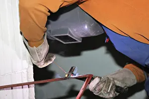 Industrial Equipment Drucke: Metal worker during welding work