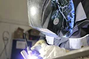 Industrial Equipment Drucke: Metalworker during welding work in his workshop