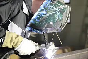 Protective Clothing For Workers Drucke: Metalworker during welding work in his workshop