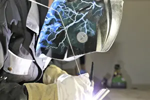 Construction Site Worker Drucke: Metalworker during welding work in his workshop