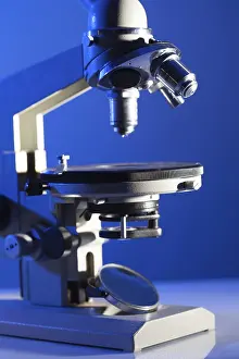 Biotechnology Research Drucke: Microscope on the table in laboratory with blue light