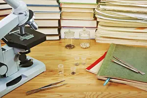 Science Experiment Setup Drucke: Microscope and test specimens of seed on the table with scientific books
