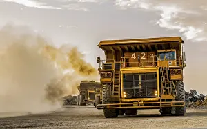 Construction Site Equipment Drucke: Mining dump trucks transporting Platinum ore for processing
