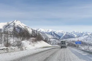 Deserted Mountain Highway Drucke: Minivan driving on the Road of Bones