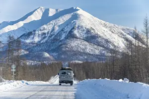 Deserted Mountain Road Drucke: Minivan driving on the Road of Bones