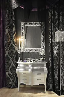 Decorative Items For Home Drucke: Mirror, a clock and burning candles in the candlestick