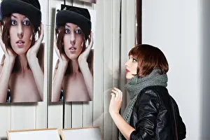 Female Model Studio Shot Drucke: Model posing in front of a showcase with her picture