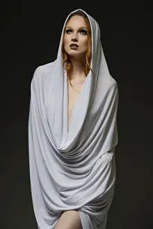 Makeup And Cosmetics Drucke: A model stands gracefully, enveloped in light fabric