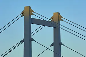 Evening Light Atmosphere Photos Drucke: A modern bridge at sunset with clear cable structures and a cloudless sky