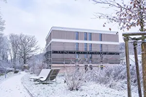 Snowy German Landscape Drucke: Modern building with snow-covered path and wintry trees
