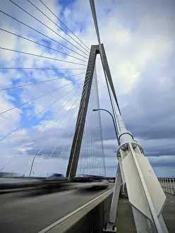 Contemporary Architectural Style USA Drucke: A modern cable-stayed bridge under a partly cloudy sky