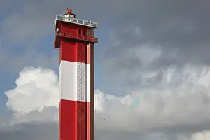 Coastal Tower Structure Drucke: Modern lighthouse in the sky with rainbow