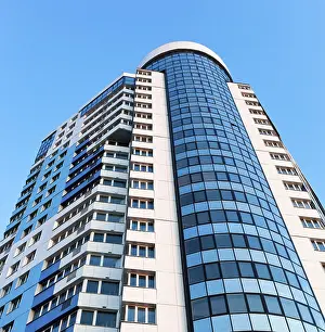 Futuristic Building Design Drucke: Modern skyscraper on blue sky background in Samara
