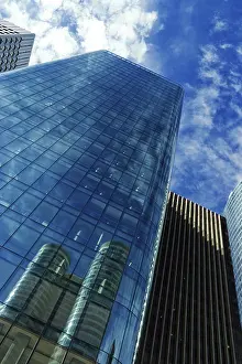 Modern Skyscraper Drucke: Modern skyscraper under cloudy blue sky