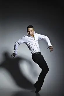 Fashionable Studio Shot Drucke: Modern style dancer posing on grey studio background