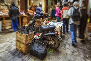 Historic Old Town Center Drucke: Moped parked between boxes, anonymous crowd in souk