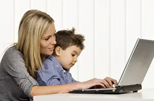 Mother Working From Home Drucke: Mother and son at the computer