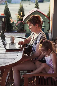 Home Office Setup Ideas Drucke: Mother working at home, using portable computer
