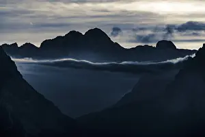 Cloudy Sky Italy Drucke: Mountain top of the Dolomites with dramatic cloudy sky