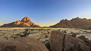 Namibia Landscape Drucke: A mountain in Namibia glows orange in the evening light