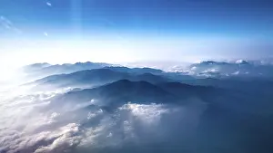 Himalayan Mountains Drucke: Mountain range above clouds under a blue sky