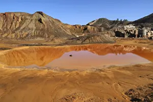 Raw Material Extraction Europe Drucke: Mountain with red puddle and mine building