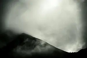 Switzerland Tourism Drucke: Mountaineer on mountain ridge with dramatic clouds