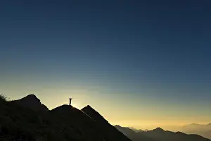 Ammergau Alps Drucke: Mountaineer on summit ridge with backlight