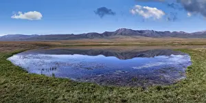 Central Asia Travel Destination Drucke: Mountains reflecting in a lake along the At-Bashy Range