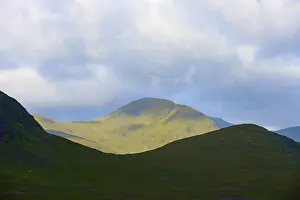 Northern Europe Nature Scenery Drucke: Mountains in sunlight against a cloudy sky