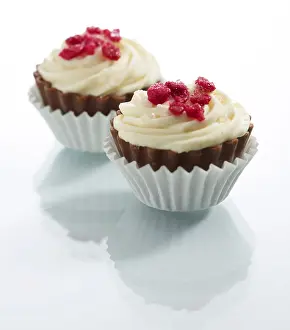 Studio Shot Dessert Drucke: Two muffins in front of a white background