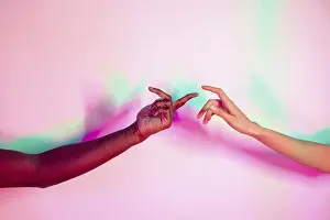 Symbolic Connection Image Drucke: Two multiethnic hands extend toward each other against a vibrant