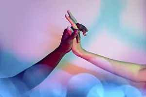 Colorful Diversity Drucke: Multiethnic hands interlock against a colorful backdrop