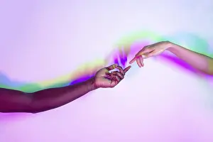 Multiethnic Unity Drucke: Two multiethnic hands reaching towards each other against a vibrant background with dynamic