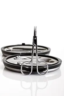 Studio Still Life Photography Drucke: Nail scissors in front of a manicure set