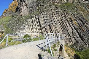 Basalt Column Formation Drucke: A narrow path with railing leads over a stone bridge